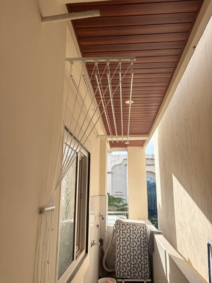 Retractable cloth drying hanger installed on a balcony