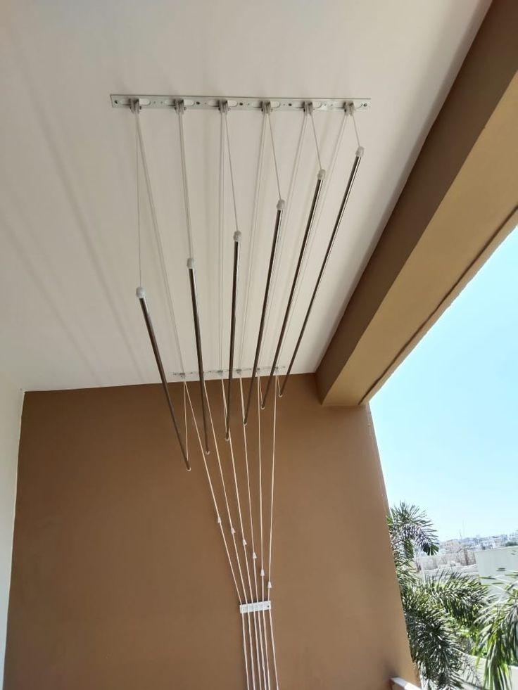 Space-saving ceiling clothes hanger installation